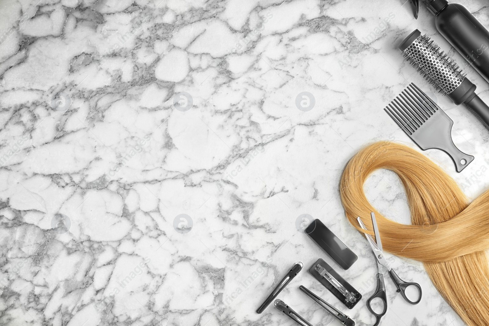 Photo of Flat lay composition with professional hairdresser tools on marble background