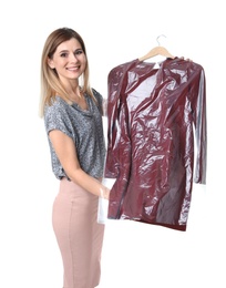 Photo of Young woman holding hanger with dress in plastic bag on white background. Dry-cleaning service