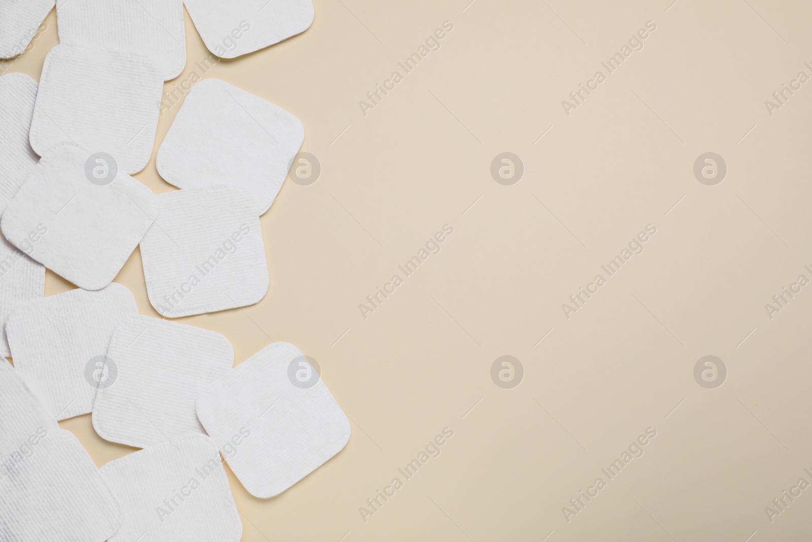 Photo of Many clean cotton pads on yellow background, flat lay. Space for text