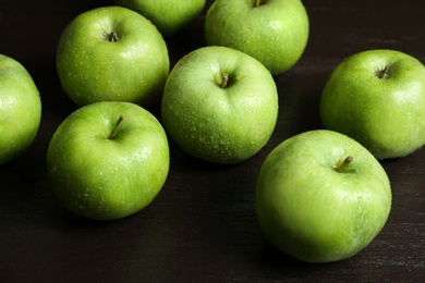 Fresh green apples on wooden background