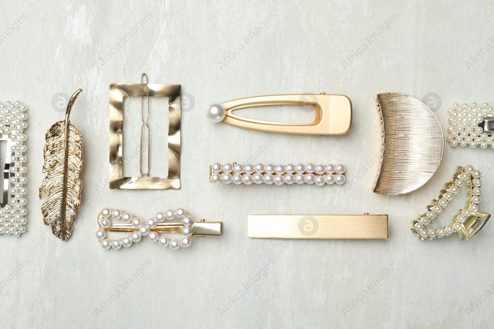 Photo of Beautiful different hair clips on white table, flat lay