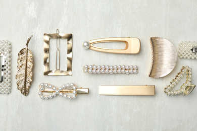 Photo of Beautiful different hair clips on white table, flat lay