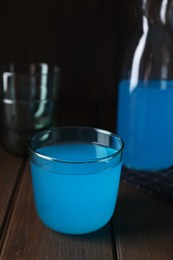 Photo of Delicious blue drink on wooden table. Space for text