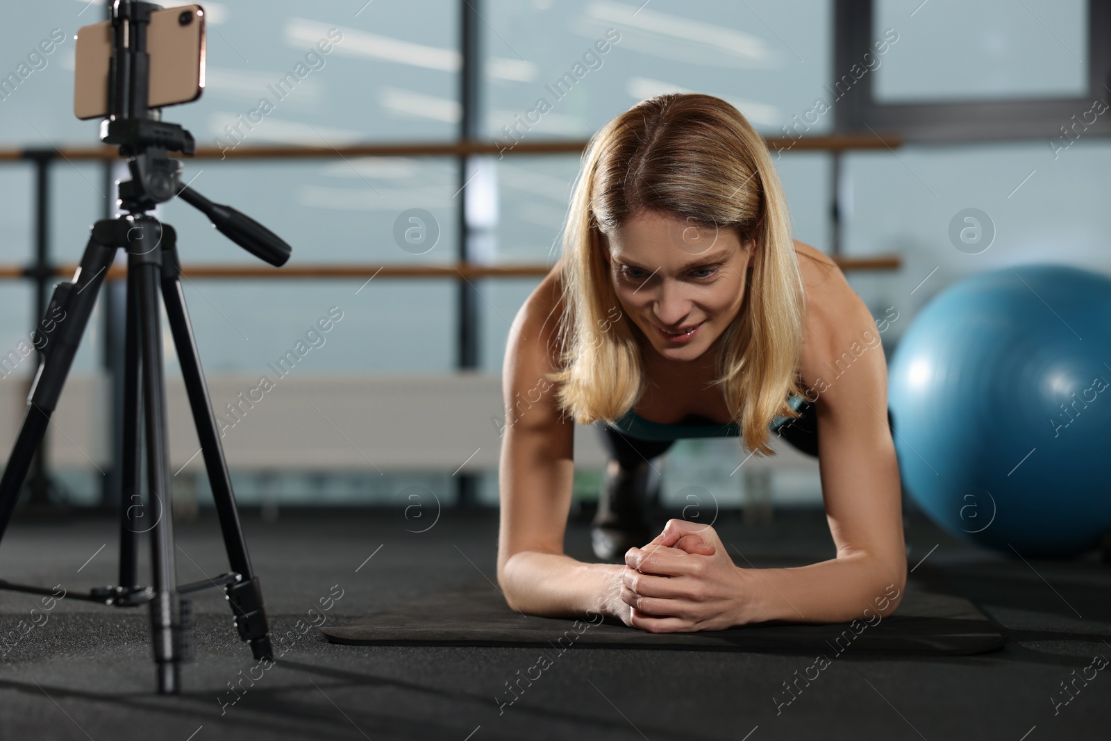 Photo of Fitness trainer recording online classes in gym