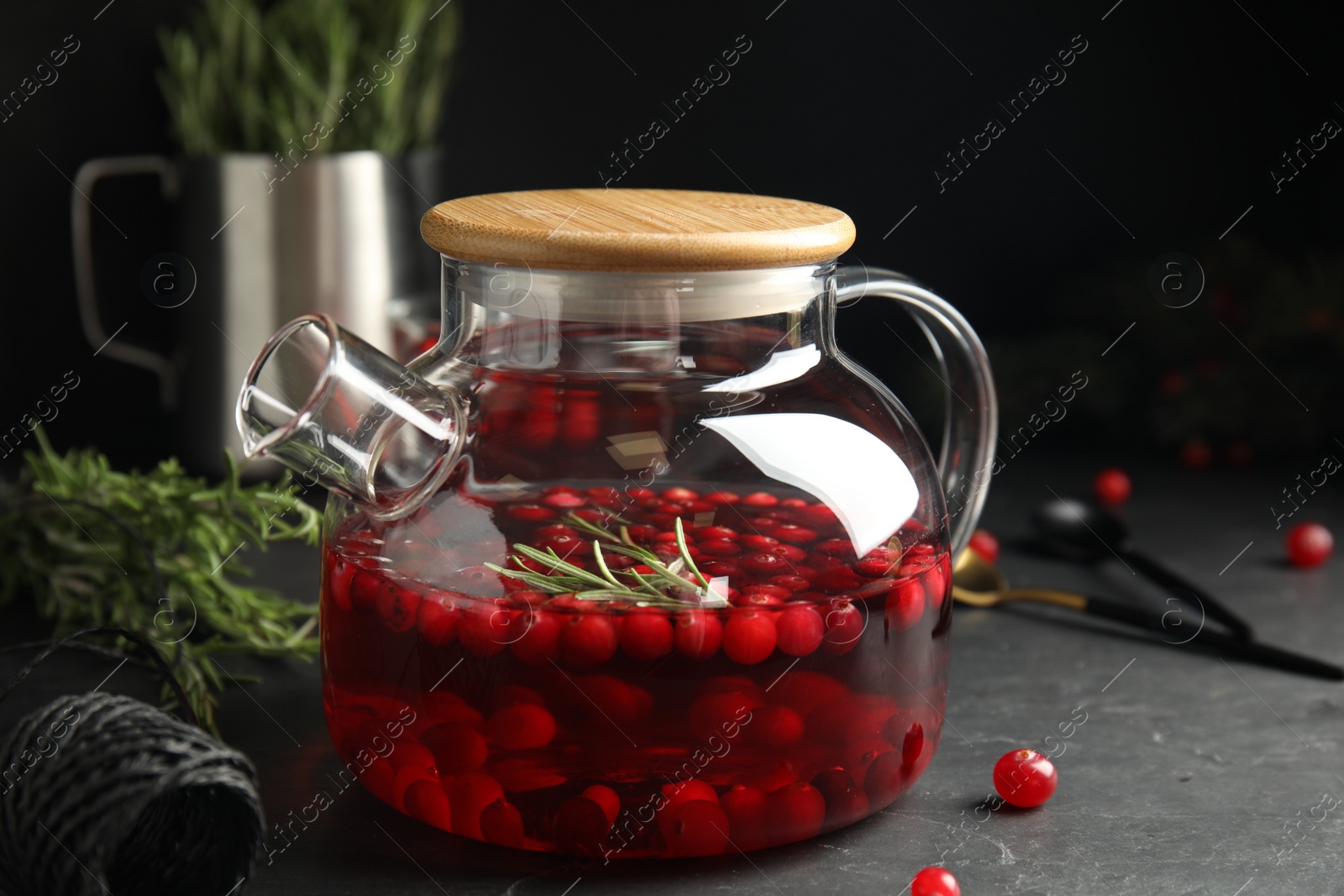 Photo of Tasty hot cranberry tea on black table