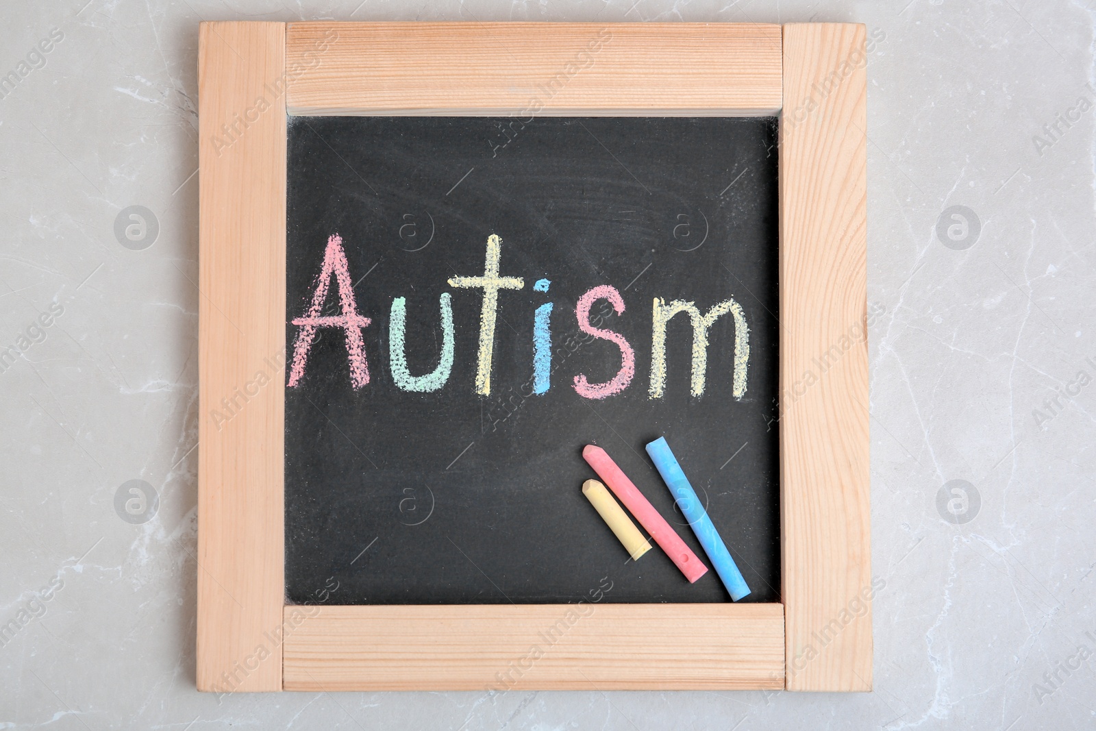 Photo of Chalkboard with word AUTISM on light background