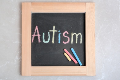 Photo of Chalkboard with word AUTISM on light background