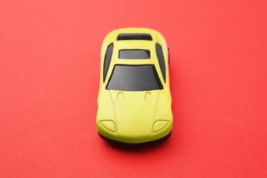 Photo of One yellow car on red background. Children`s toy