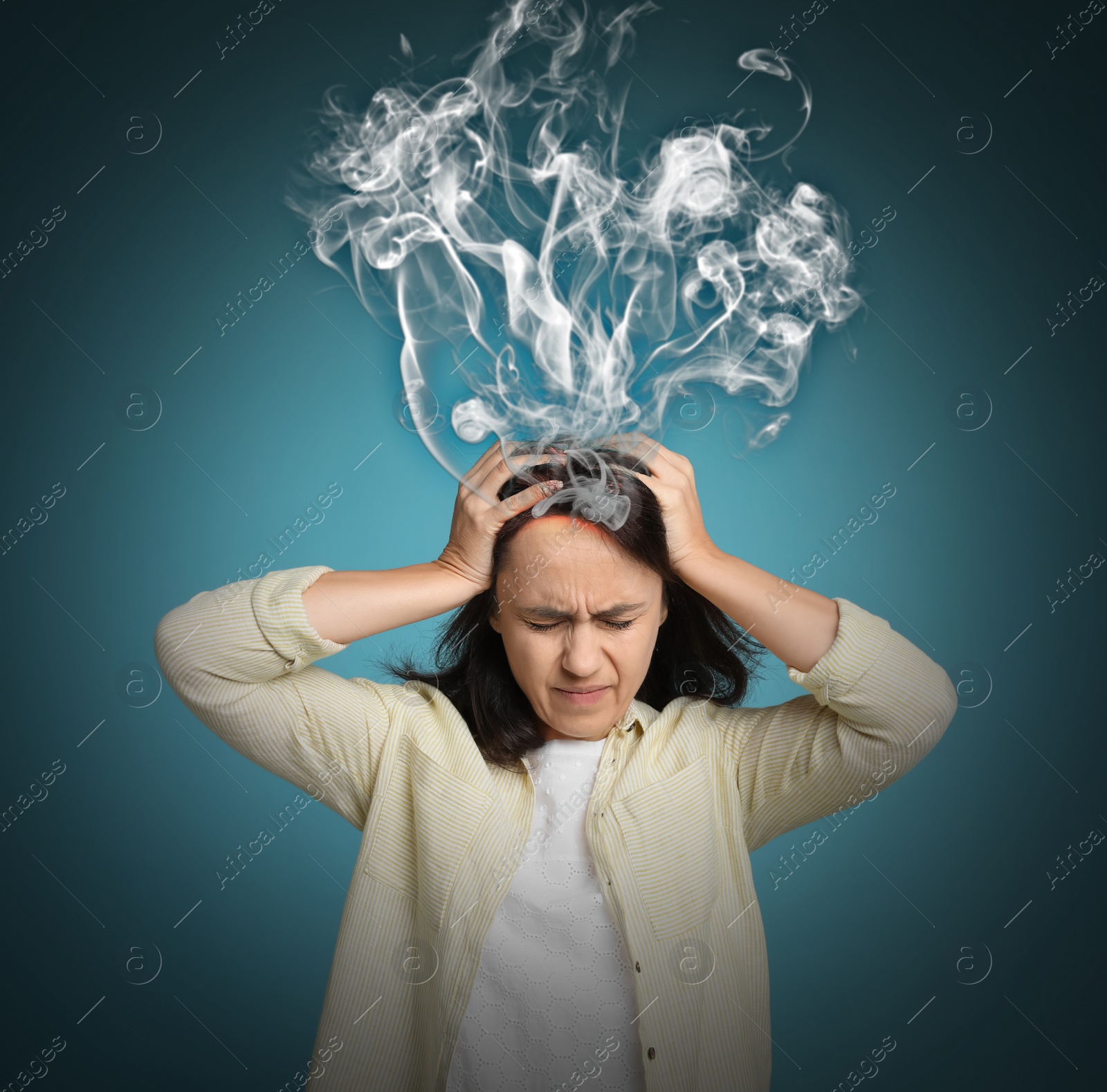 Image of Mature woman having headache on blue background. Illustration of smoke representing severe pain