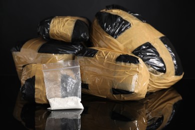 Smuggling and drug trafficking. Packages with narcotics on black mirror surface