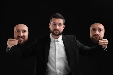 Man holding masks with his face showing different emotions on black background. Balanced personality