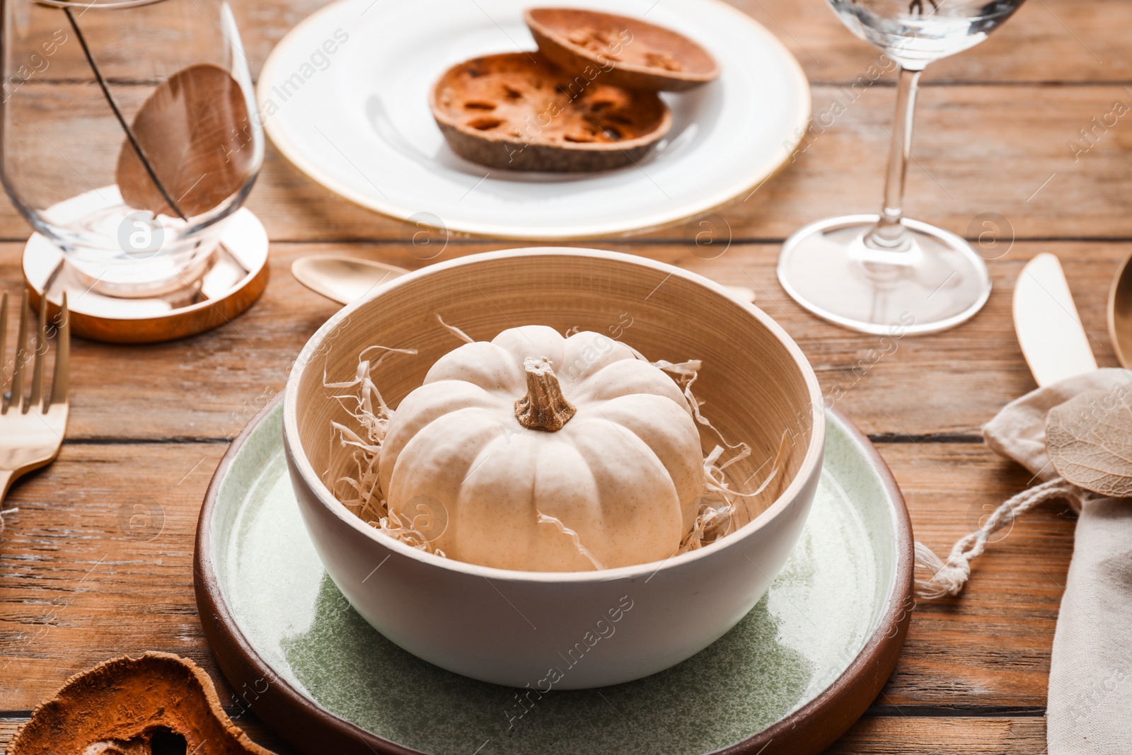 Photo of Autumn table setting with pumpkin and decor on wooden background