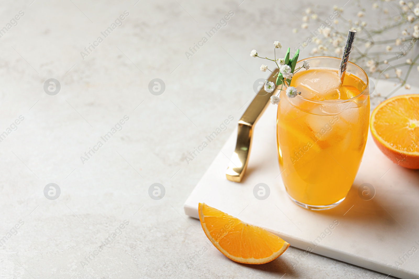 Photo of Delicious orange soda water on light table. Space for text