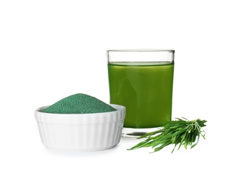 Photo of Glass of spirulina drink, bowl with powder and wheat grass on white background
