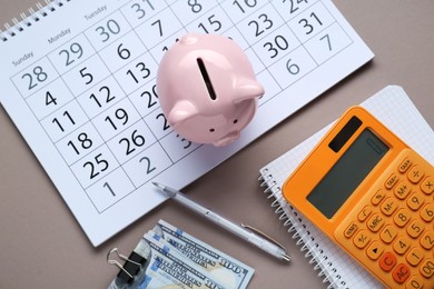 Photo of Flat lay composition with piggy bank and calculator on grey background