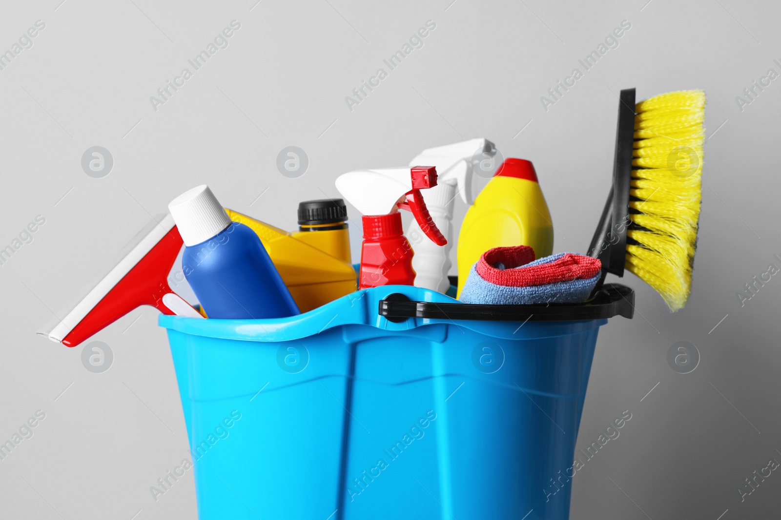 Photo of Different car products in bucket on white background