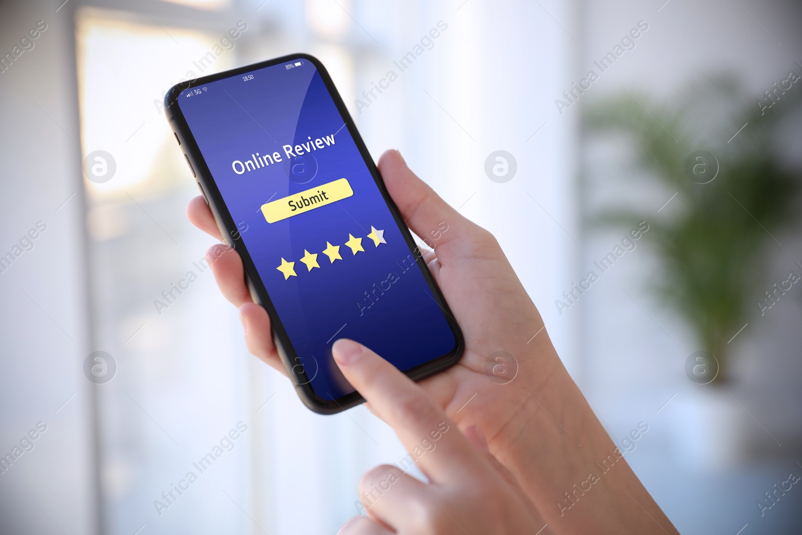 Image of Woman using smartphone to give feedback indoors, closeup. Customer review