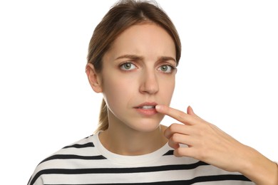 Photo of Woman with herpes applying cream onto lip against white background
