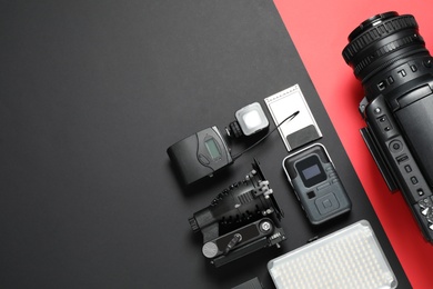 Photo of Flat lay composition with camera and video production equipment on color background. Space for text