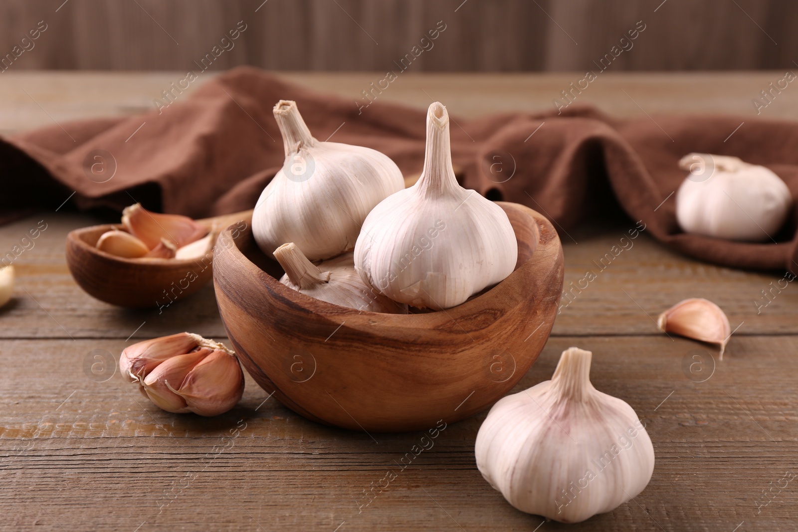 Photo of Fresh garlic on wooden table, closeup view