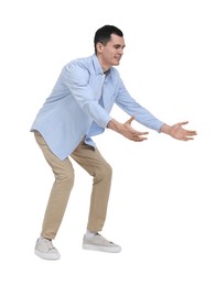 Photo of Young man in light blue shirt and beige pants on white background