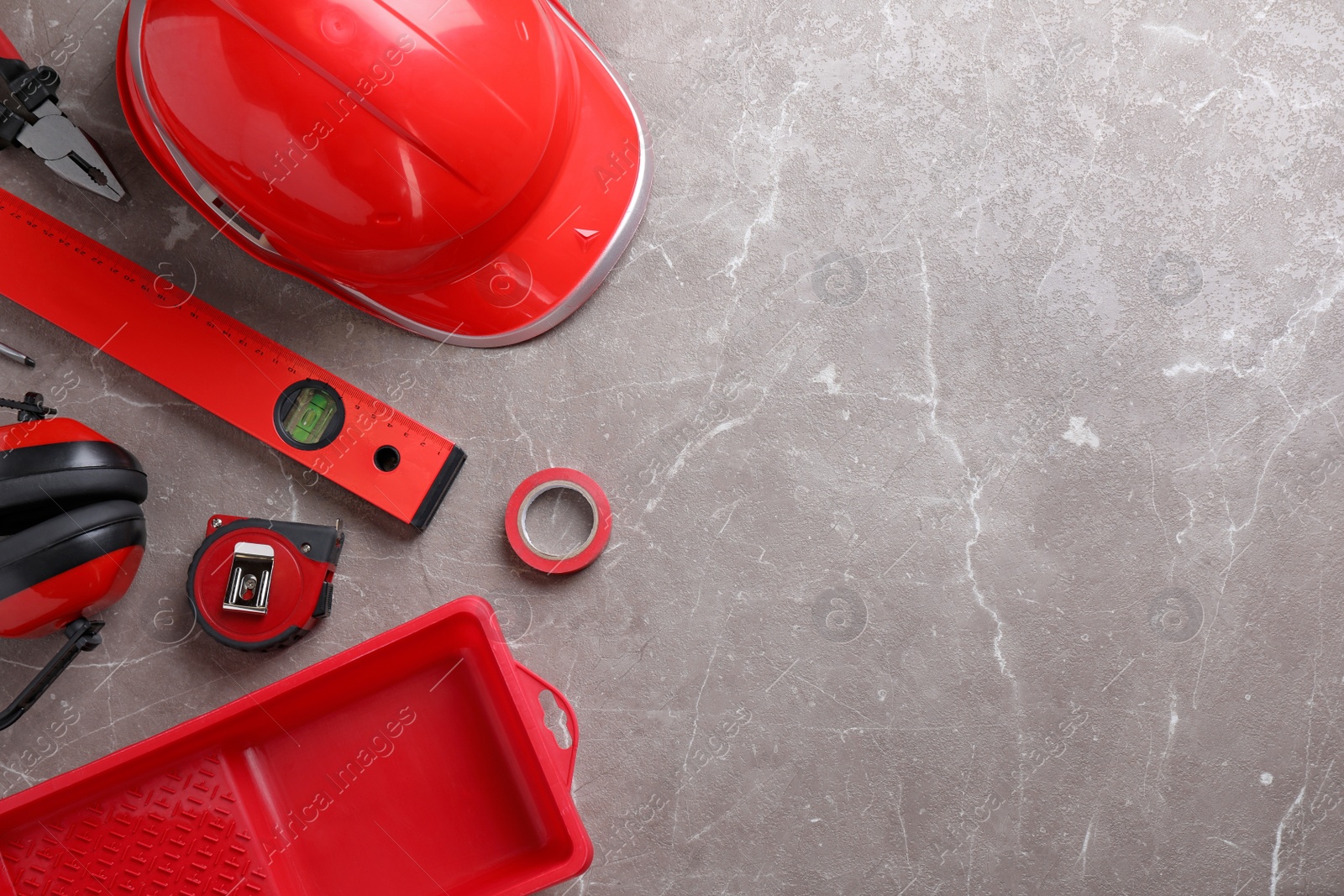 Photo of Flat lay composition with different construction tools on grey marble background. Space for text