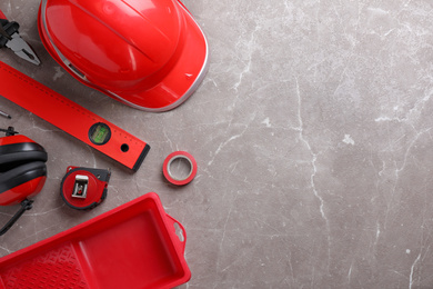 Flat lay composition with different construction tools on grey marble background. Space for text