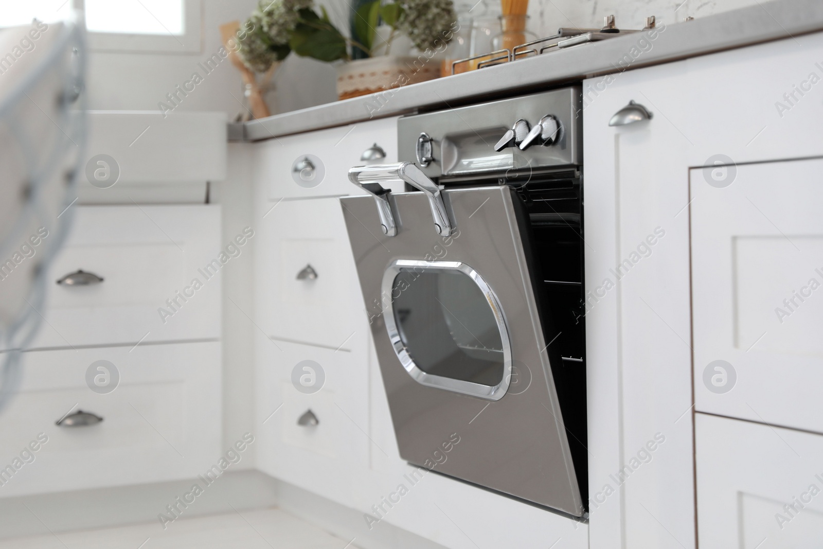 Photo of New modern oven in stylish kitchen. Cooking appliance