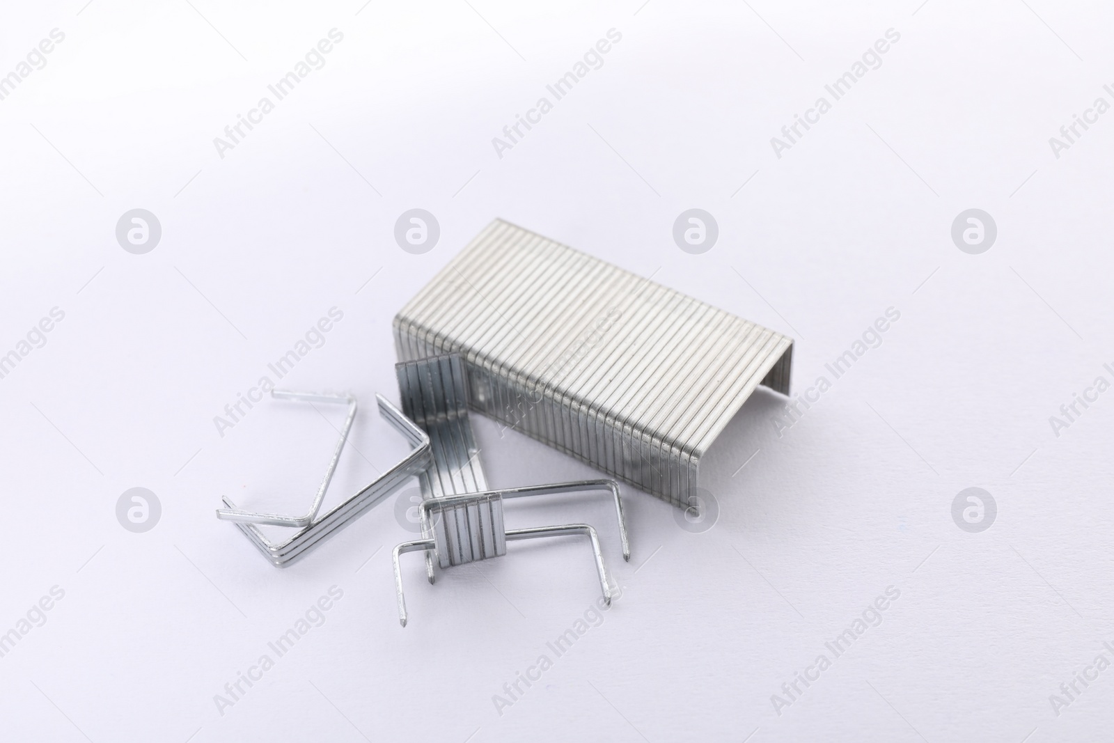 Photo of Staple gun refills on white background. Office supplies