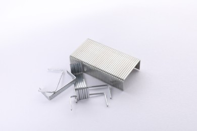 Photo of Staple gun refills on white background. Office supplies