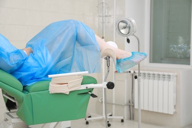 Photo of Gynecological checkup. Woman lying on examination chair in clinic, closeup