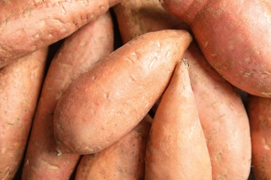 Photo of Pile of sweet potatoes as background, top view