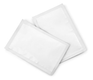 Photo of Two blank medicine sachets on white background, top view