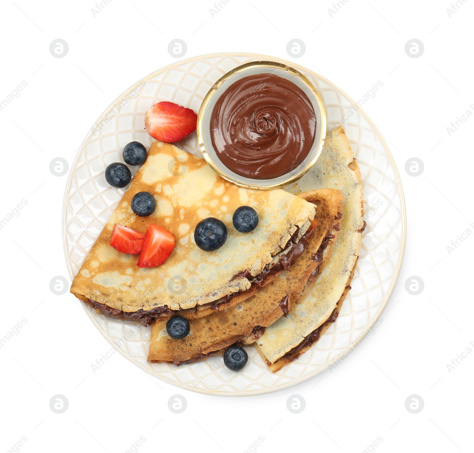 Photo of Tasty crepes with chocolate paste and berries isolated on white, top view