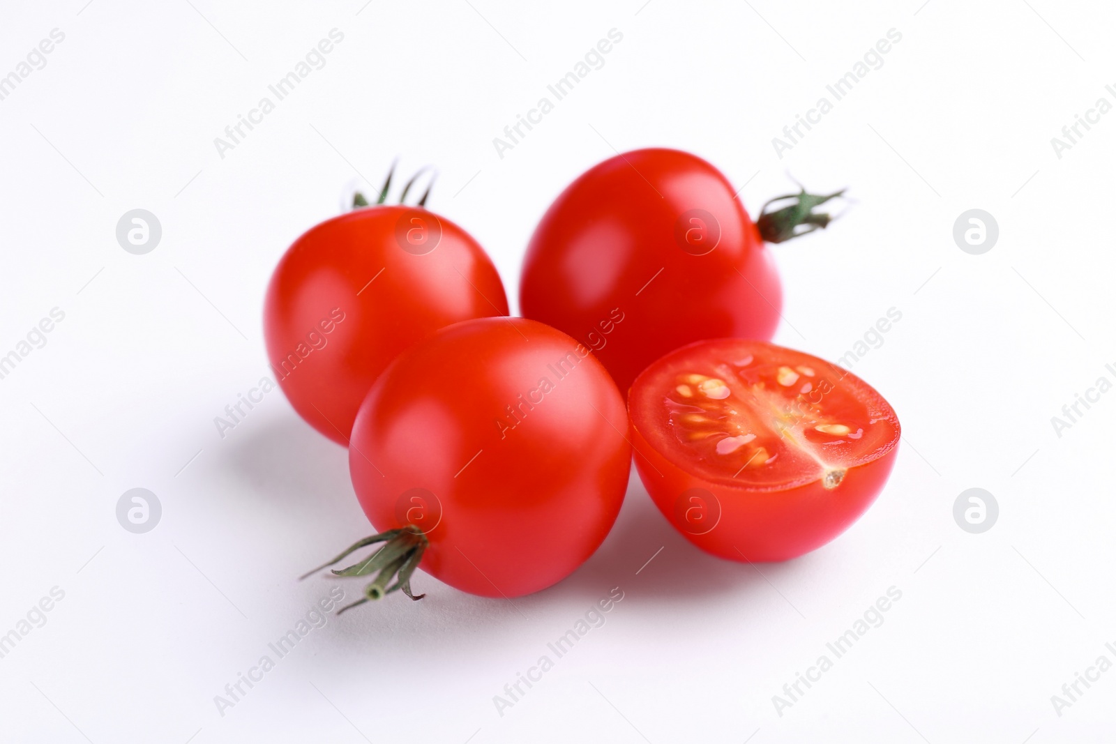 Photo of Whole and cut ripe tomatoes on white background