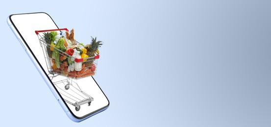 Image of Online purchases. Shopping cart with different products riding out from smartphone on grey background. Banner design with space for text