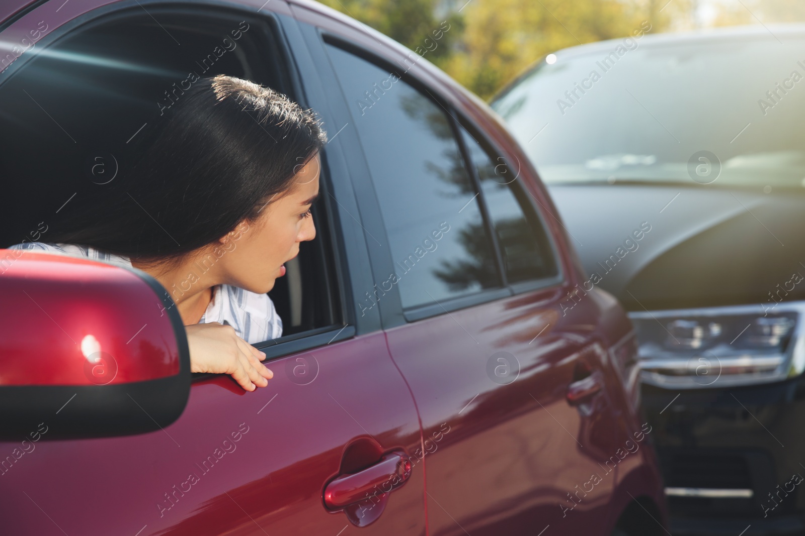 Photo of Young woman getting in car accident outdoors