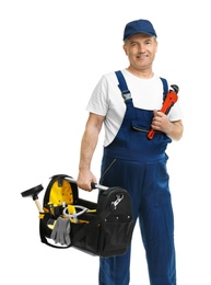 Mature plumber with pipe wrench and tool bag on white background