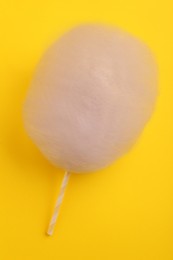 One sweet cotton candy on yellow background, top view