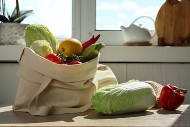 Fresh Chinese cabbage and other products on wooden table indoors