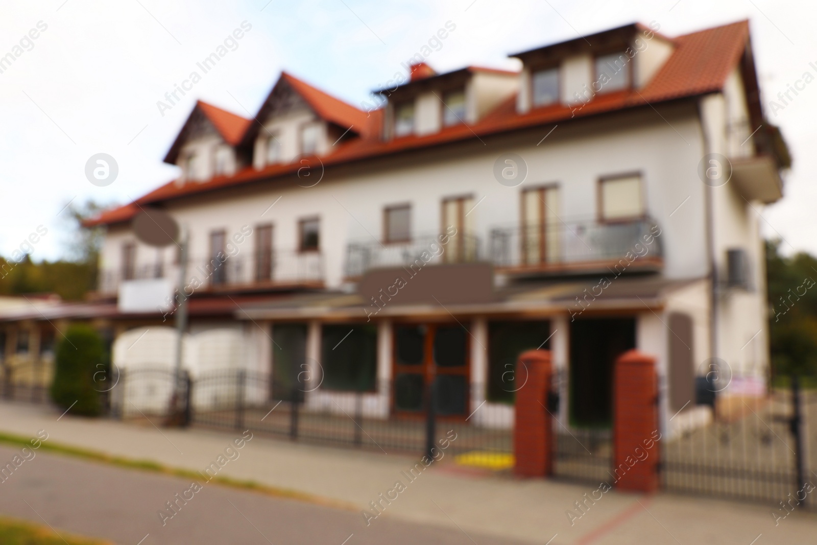 Photo of Beautiful cottage house outdoors, blurred view. Real estate for rent