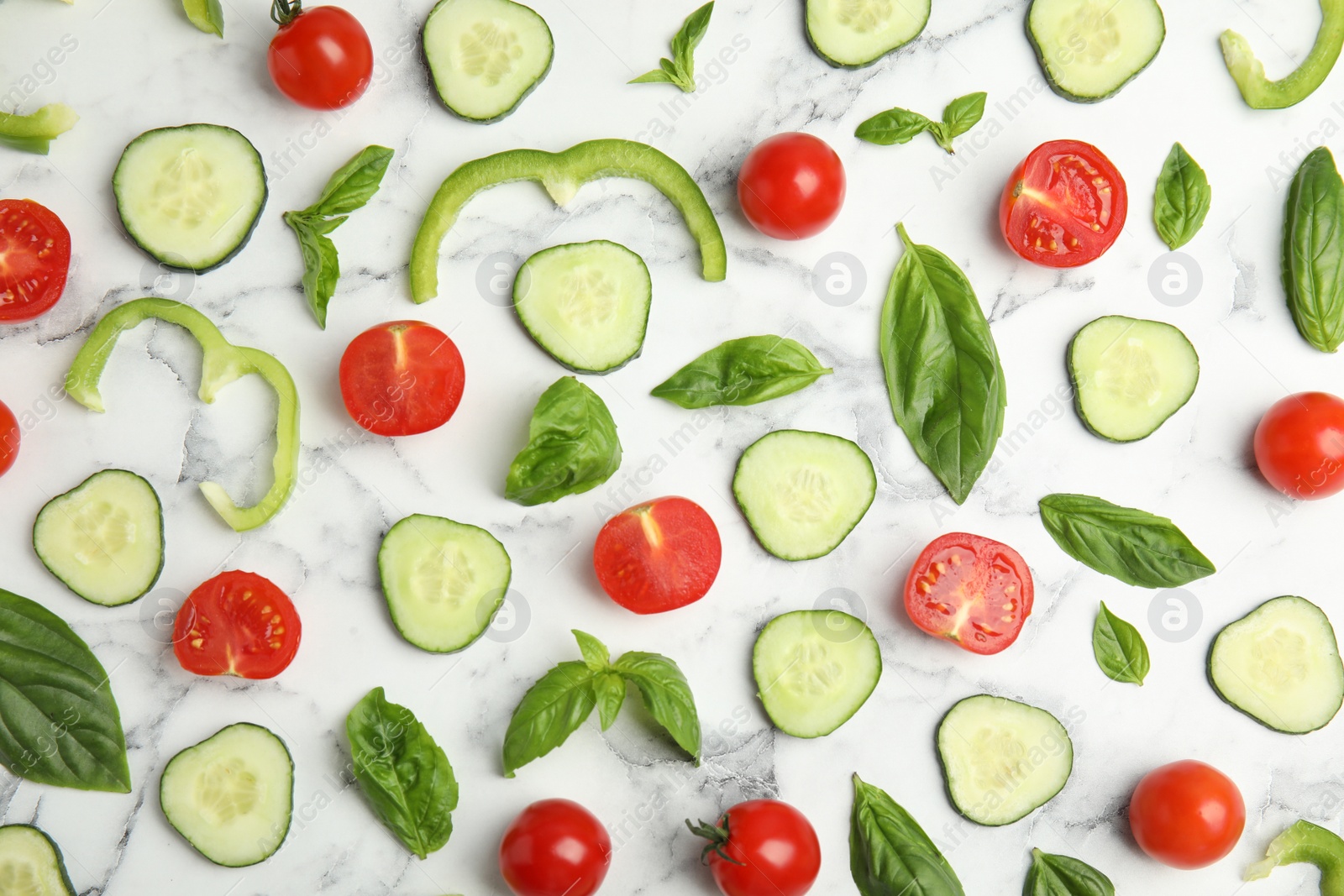 Photo of Flat lay composition with fresh salad ingredients on white marble table