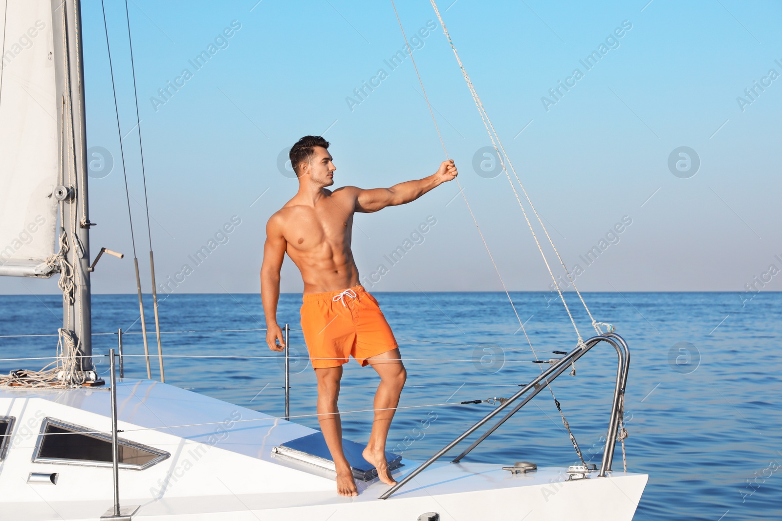 Photo of Young man relaxing on yacht during sea trip