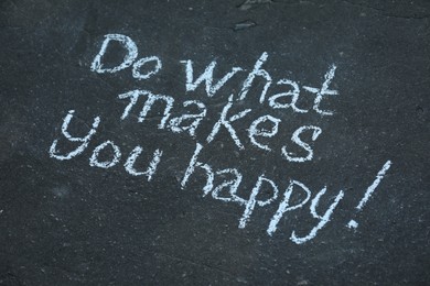 Photo of Phrase Do What Makes You Happy with exclamation mark written on asphalt