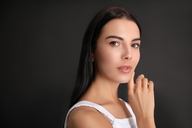 Photo of Portrait of beautiful young woman on black background