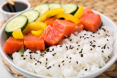 Photo of Delicious poke bowl with salmon, rice and vegetables on table, closeup