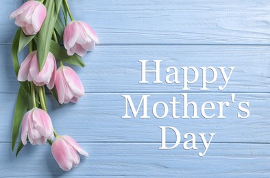 Image of Happy Mother's Day. Beautiful tulips on light blue wooden background, flat lay