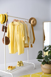 Rack with stylish women's clothes indoors. Interior design