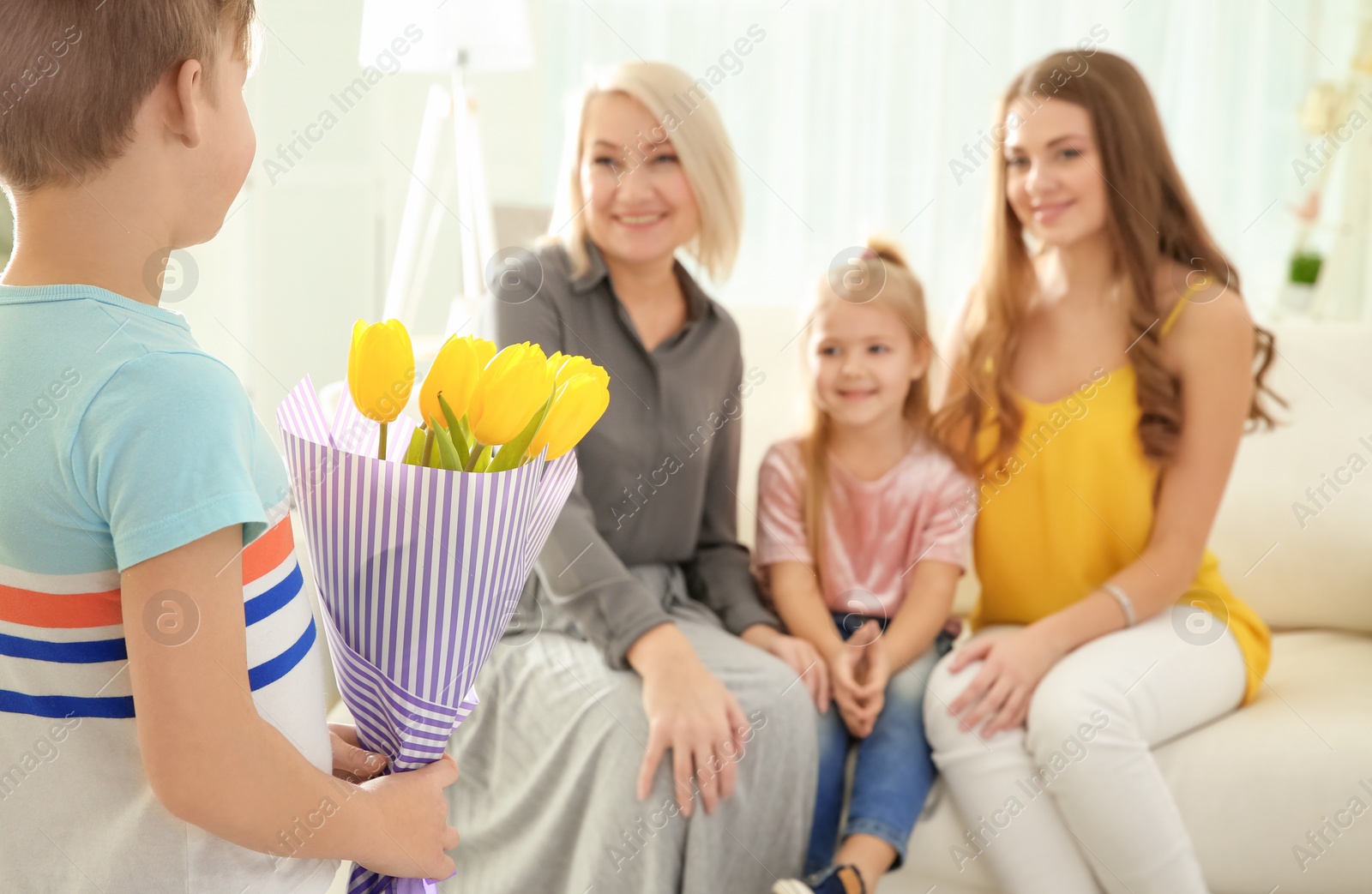 Photo of Little boy congratulating his family at home