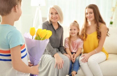 Photo of Little boy congratulating his family at home